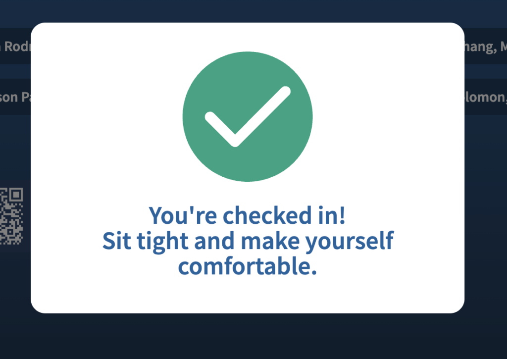 A screenshot which shows a white checkmark on a green background, underneath which is the message, "You're checked in! Sit tight and make yourself comfortable."