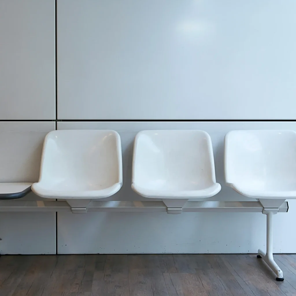 empty white chairs in the reception area of a law office