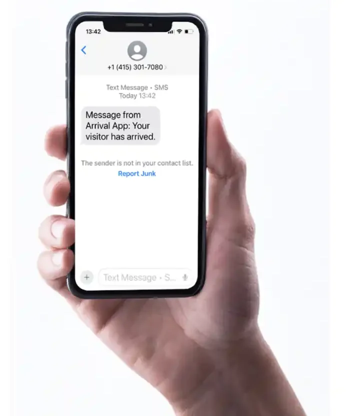 an iPhone with a text message showing that the person has arrived